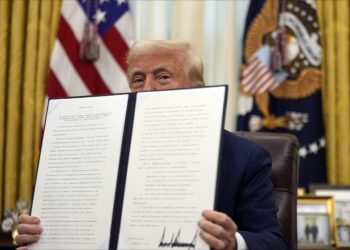 President Donald Trump holds a signed an executive order regarding the declassification and release of records relating to the assassinations of former President John F. Kennedy, Sen. Robert F. Kennedy and Rev. Martin Luther King, Jr., in the Oval Office of the White House, Thursday, Jan. 23, 2025, in Washington. (AP Photo/Ben Curtis)