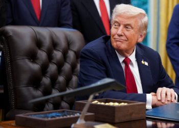 U.S. President Donald Trump sits the Oval Office to sign an executive order on AI and pediatric cancer research, at the White House, Washington, D.C., U.S., September 30, 2025. REUTERS/Nathan Howard